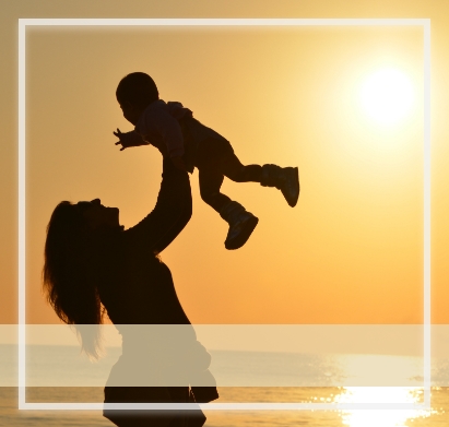 Mother tossing baby silhouette - The Luminous Woman Workshop