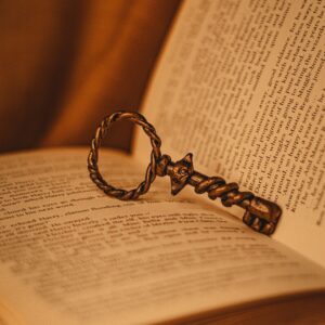 antique key propping open a book