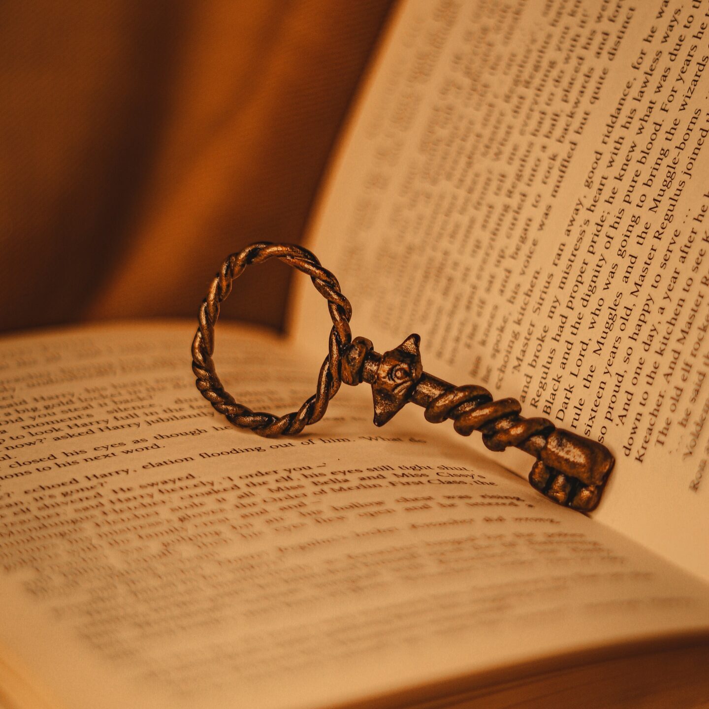 antique key propping open a book